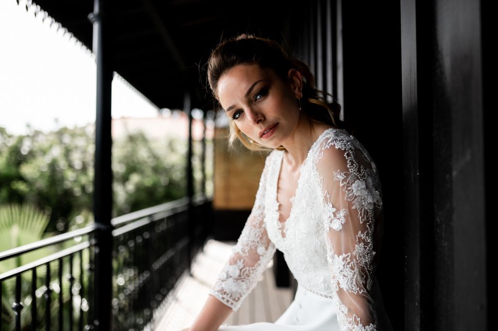 Dramatic black and white bridal portraits captured in a shadowy corridor.