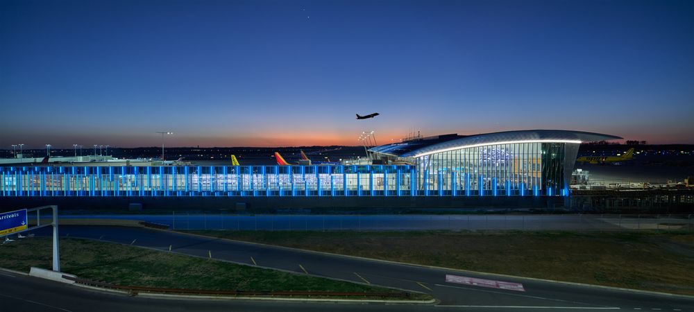 Sunset skyline view of passenger jet taking off at at the Charlotte Douglas International Airport by Cincinnati photographer Studio 66