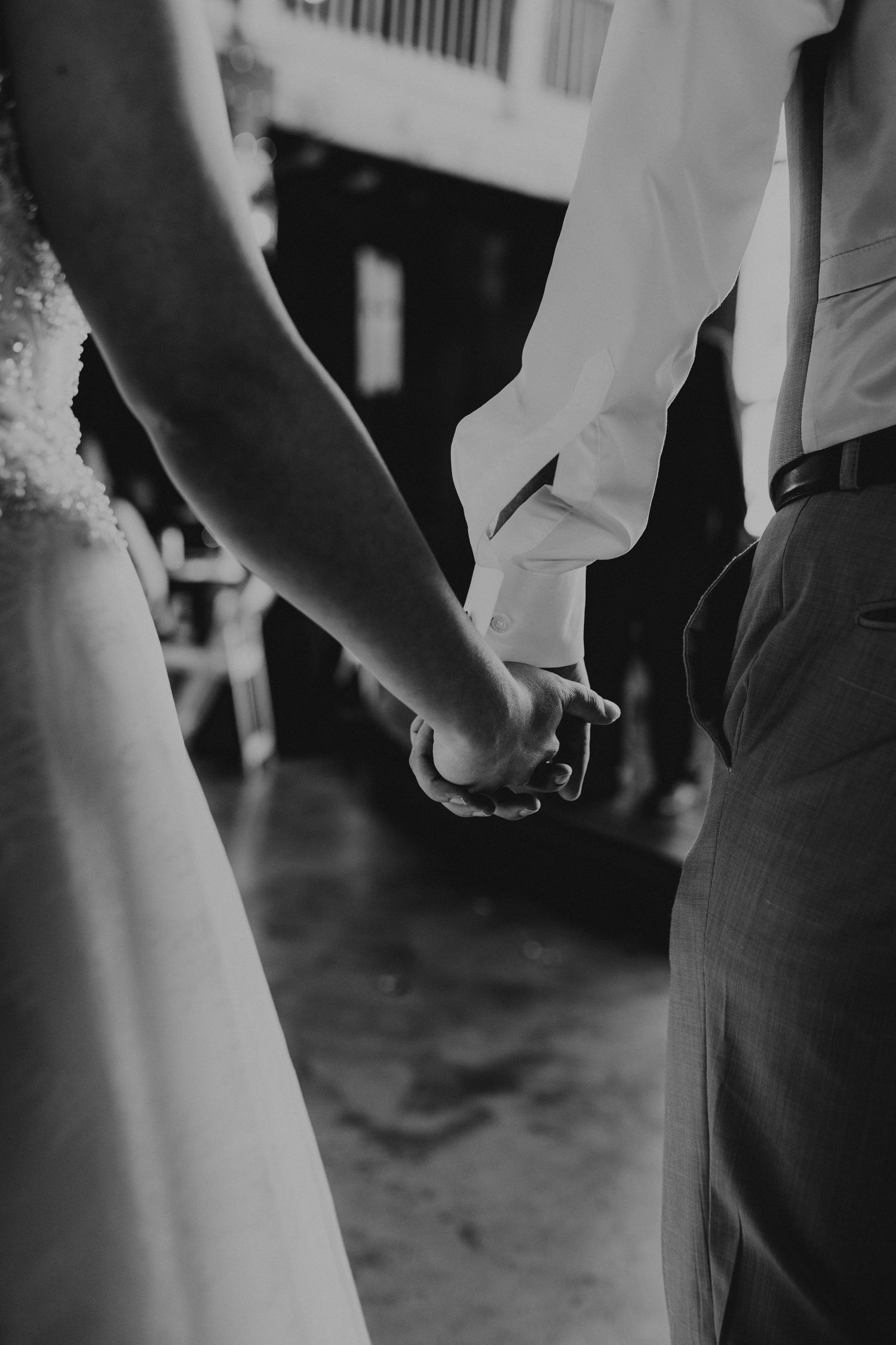 bride and groom holding hands
