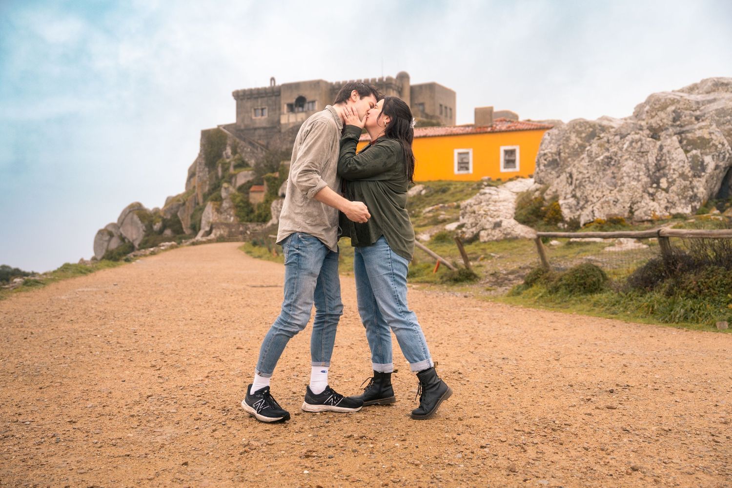 Engagement proposal scene unfolding against a coastal mountain backdrop.