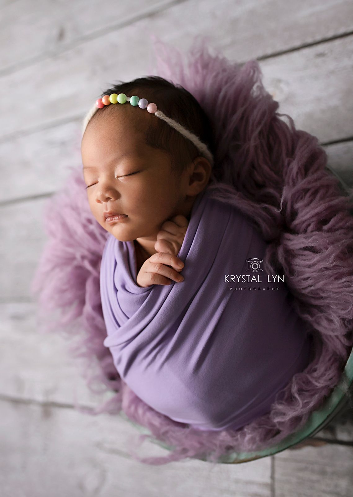 Purple newborn props for this sleepy baby girl
