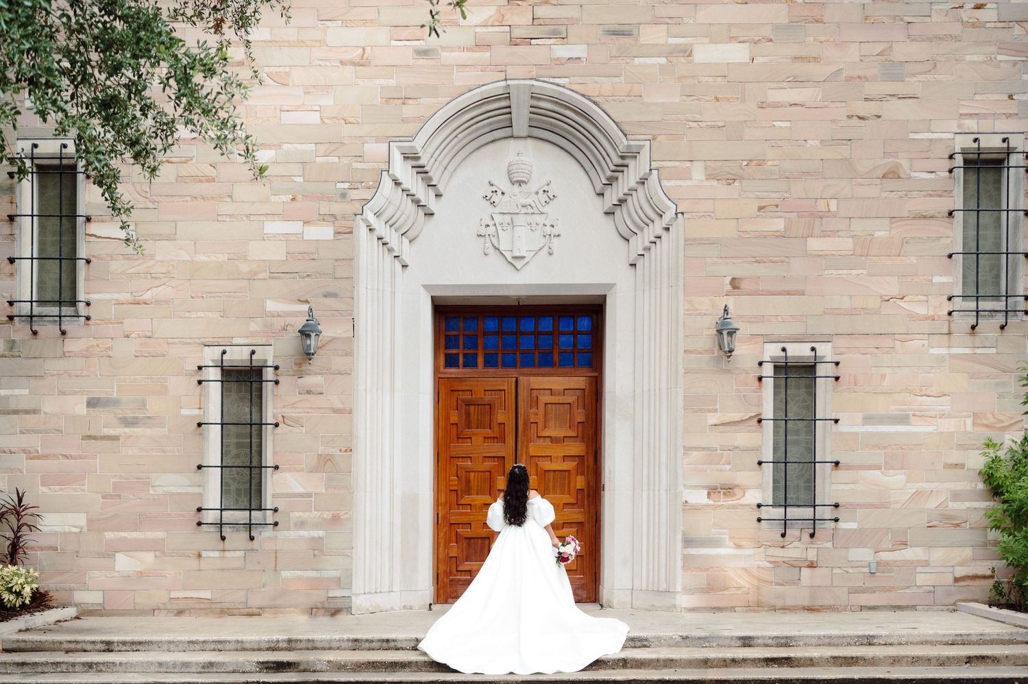 Bride in front of Catholic church.