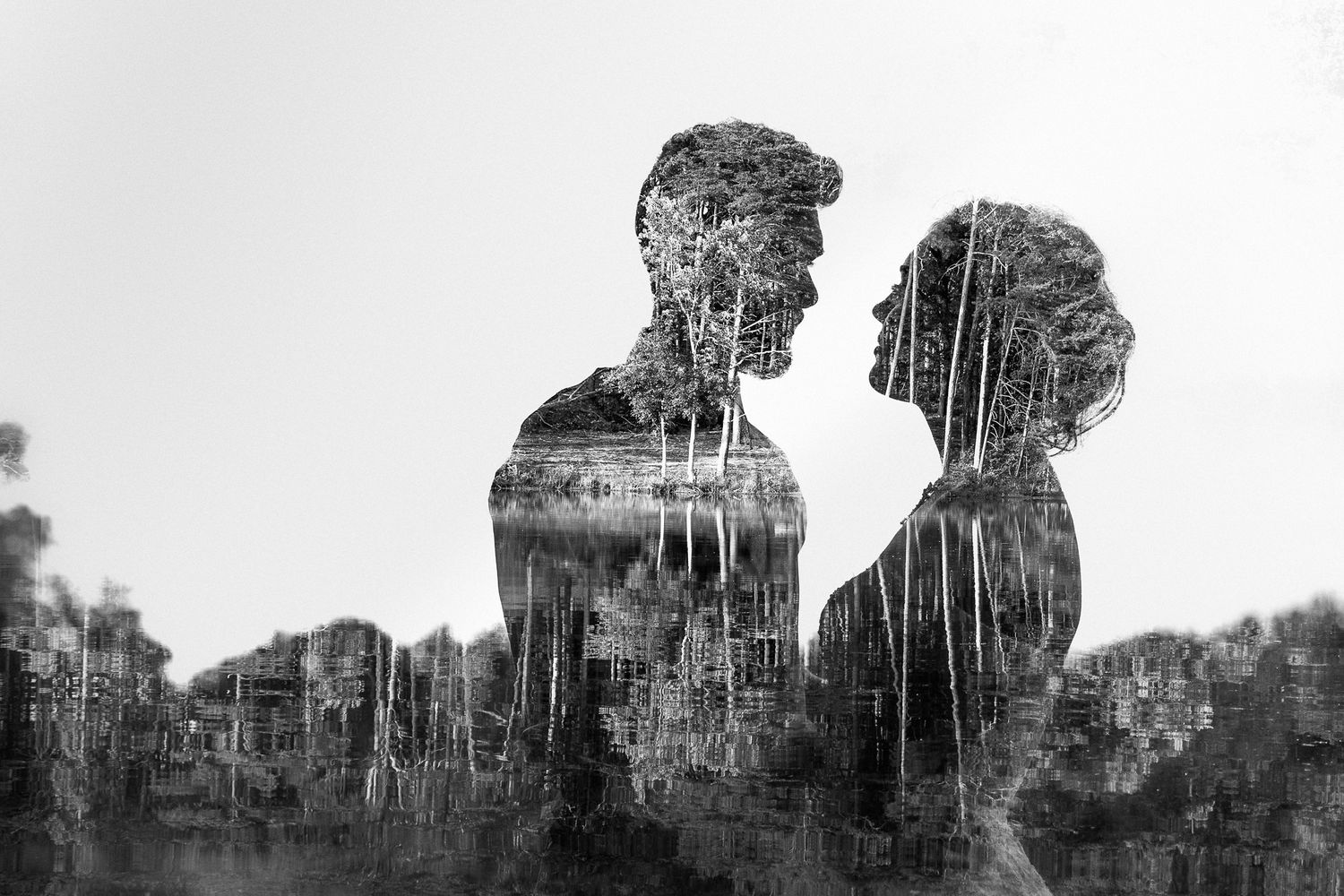 An artistic double exposure silhouette portrait showing a romantic couple against a forest backdrop.