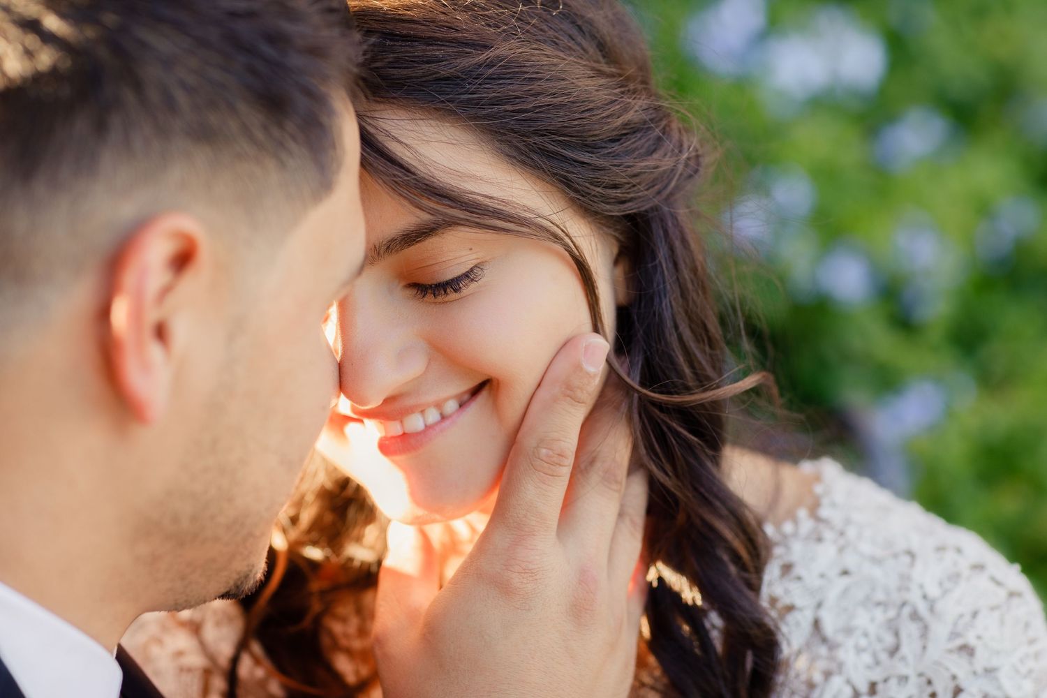 Intimate close-up of tender moment between couple with soft natural lighting.