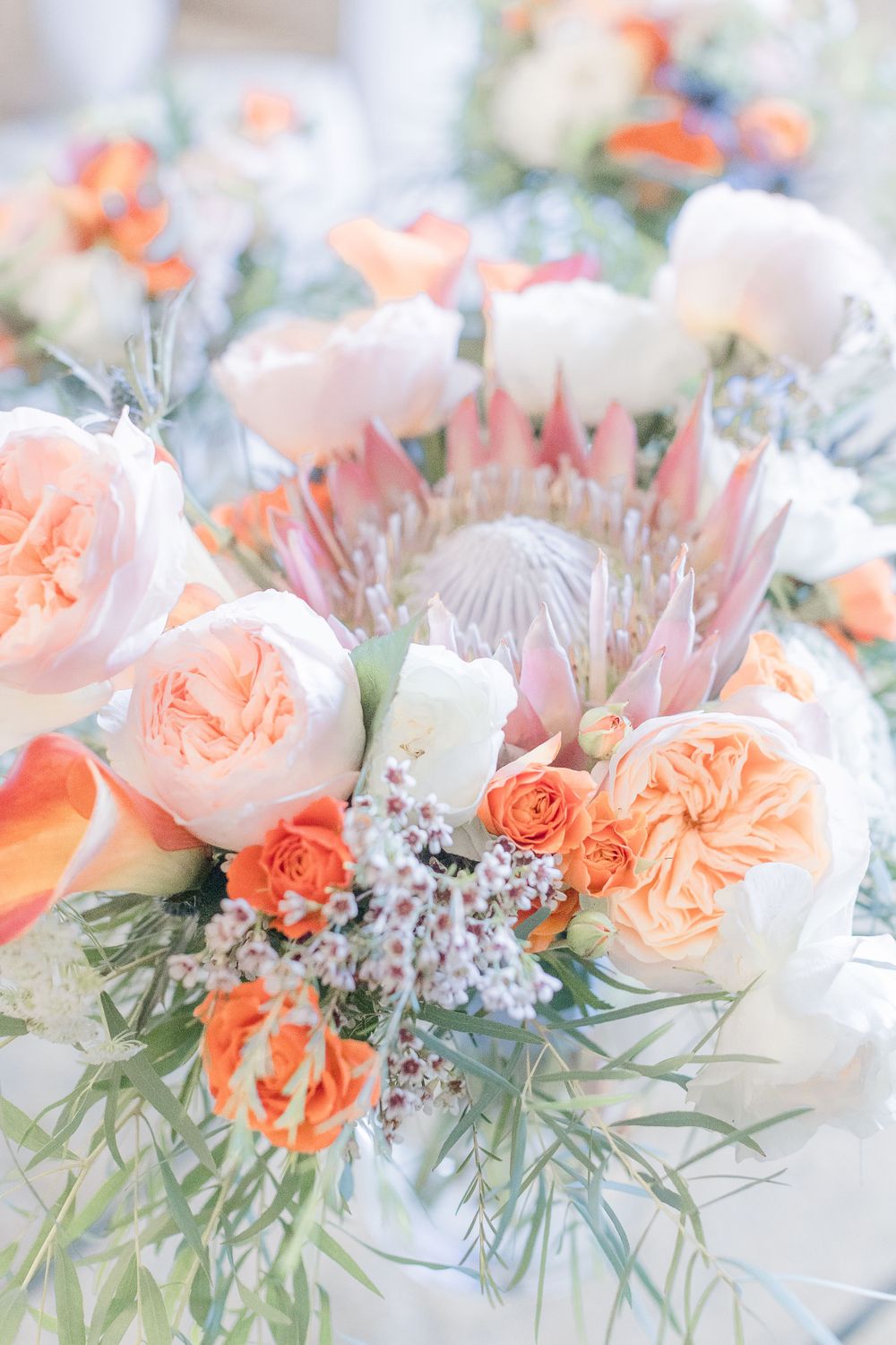 Orange,  white, and green airy peony wedding florals