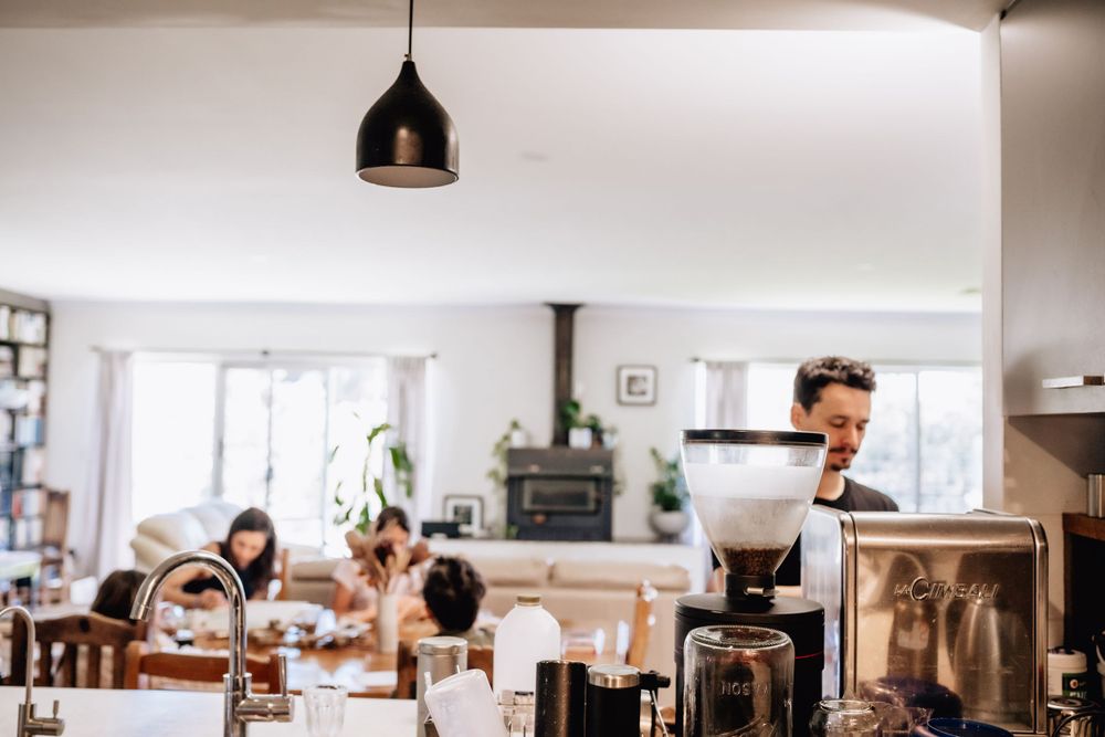 A man making coffee at a machine in his home in Perth
