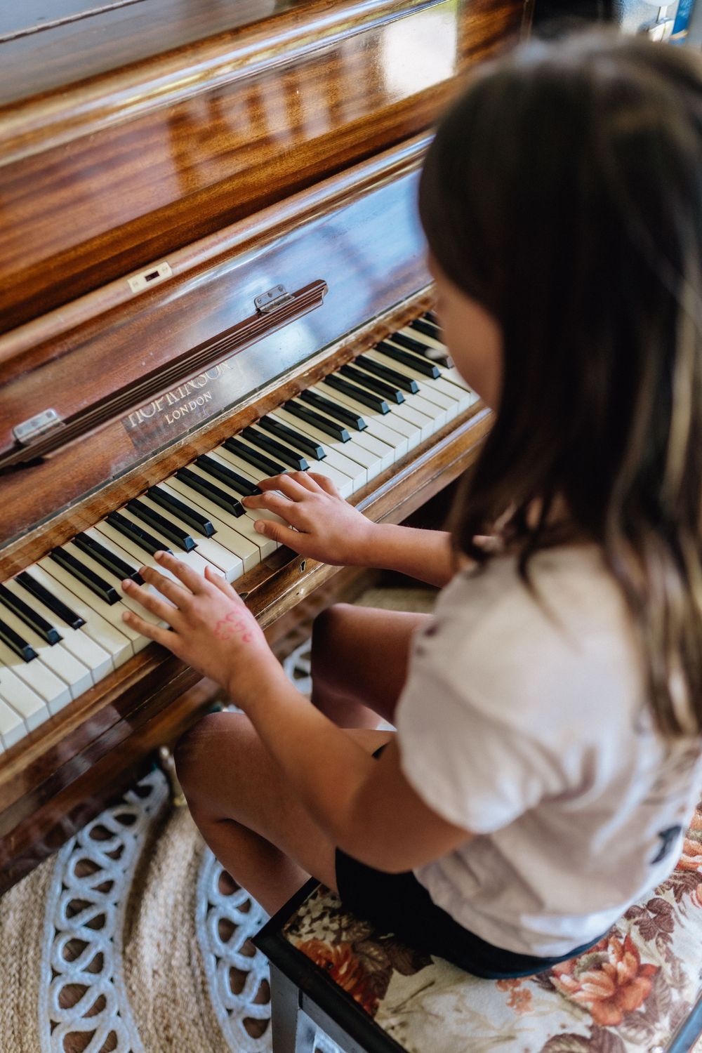 A young girl playing the piano during a family photo session