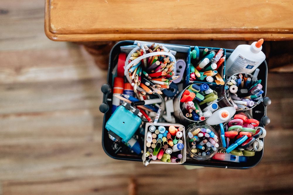 A Birds Eye image of a colorful craft caddy with pens and pencils
