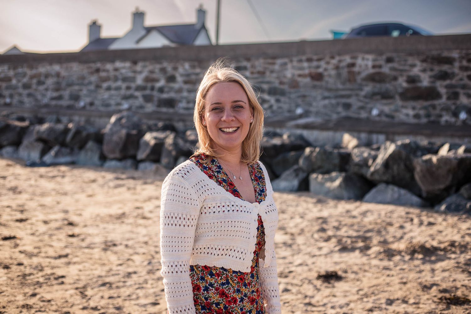 Image of Redditch photographer Holly Hancocks on the beach, smiling at the camera
