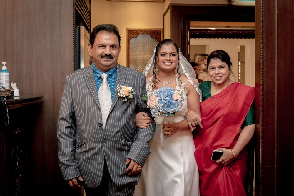 Wedding party photo in a traditional restaurant interior setting.