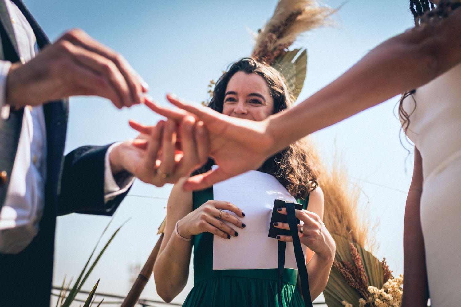 Event guests passing items and interacting during a rooftop gathering.