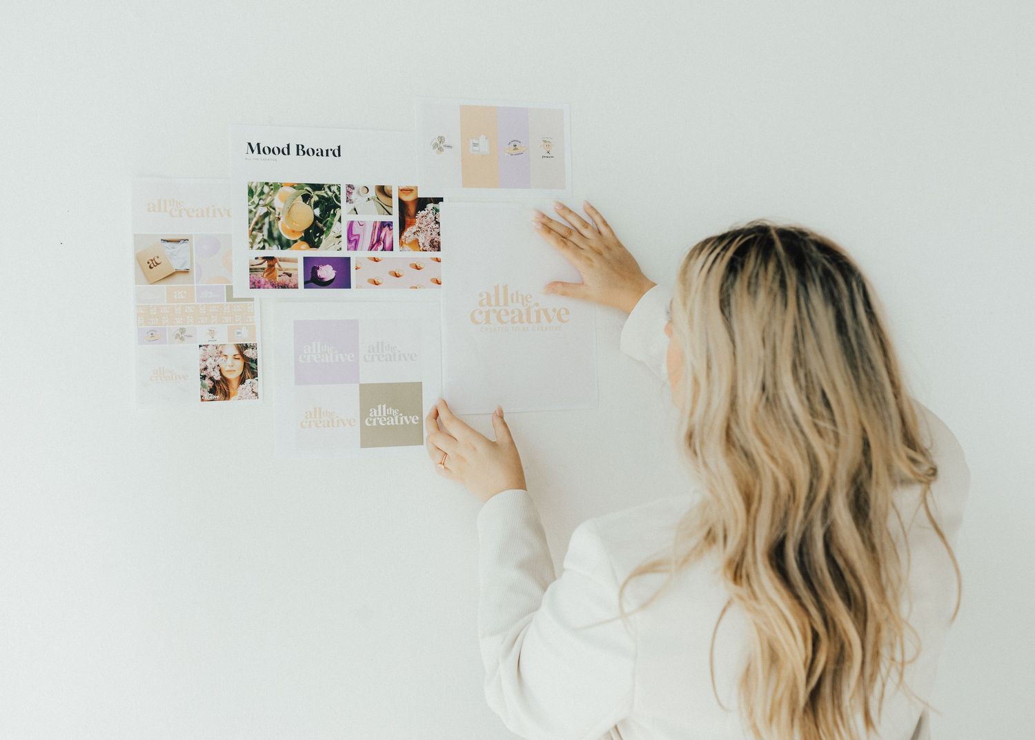 Woman putting photos on the wall