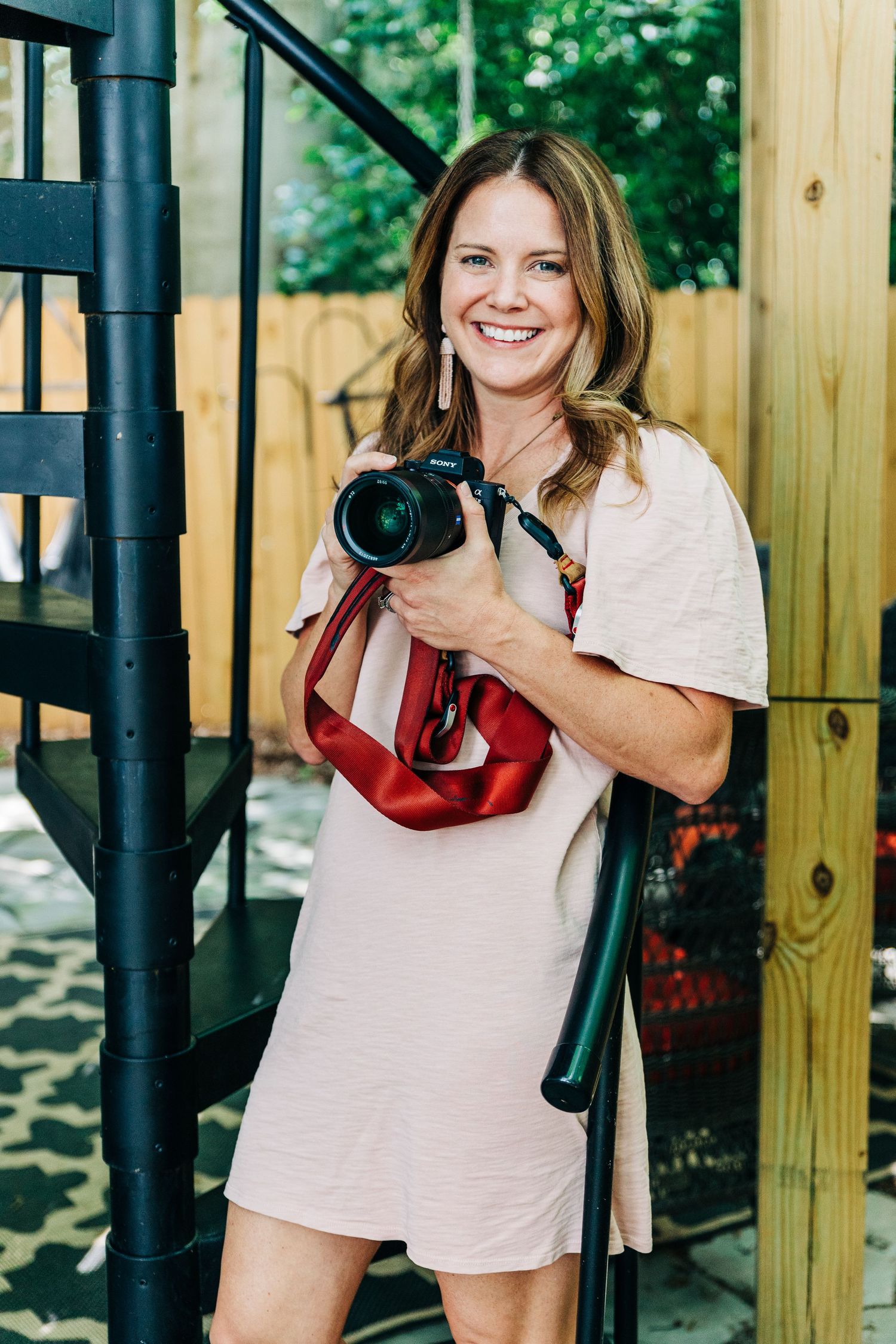 photographer poses with her camera in Charlotte
