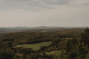 Scenic autumn landscape view of rolling hills and forests stretching to the horizon.