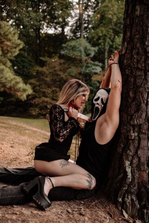 Dramatic outdoor portrait session featuring black lace and forest scenery.