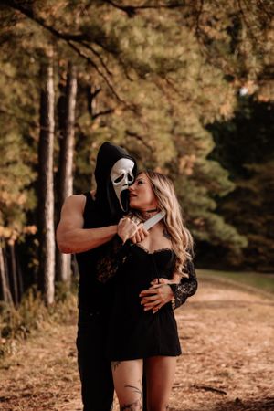 Artistic forest photoshoot featuring dramatic poses and black attire.