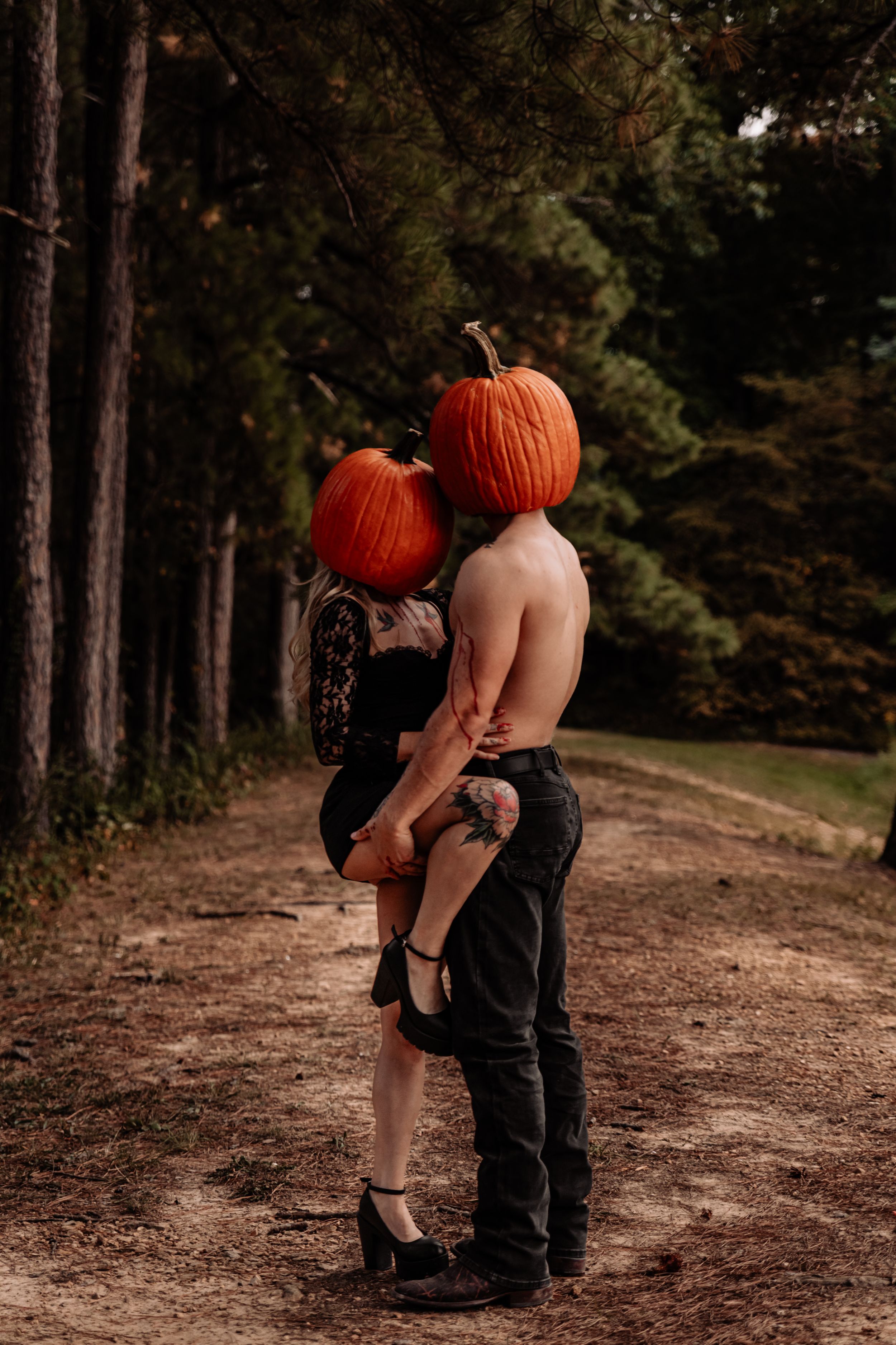 Artistic sequence showing figures with pumpkin heads in intimate poses along a forest trail.