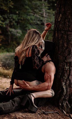 Romantic forest photography session with natural lighting and pine tree backdrop.