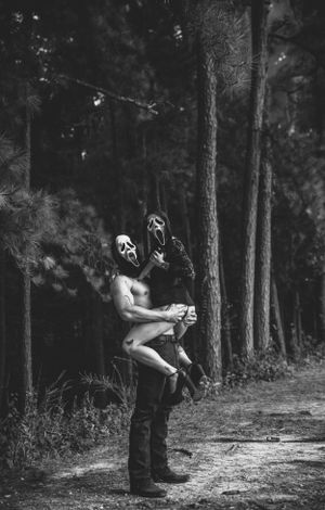 Black and white forest photography with artistic poses and masks.