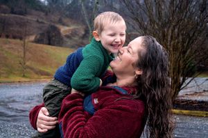 A joyful outdoor moment showing playful interaction and laughter in a natural setting.