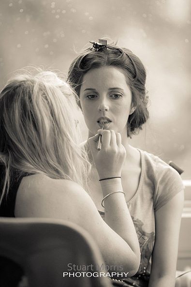 makeup artist goes to work on the brides lips