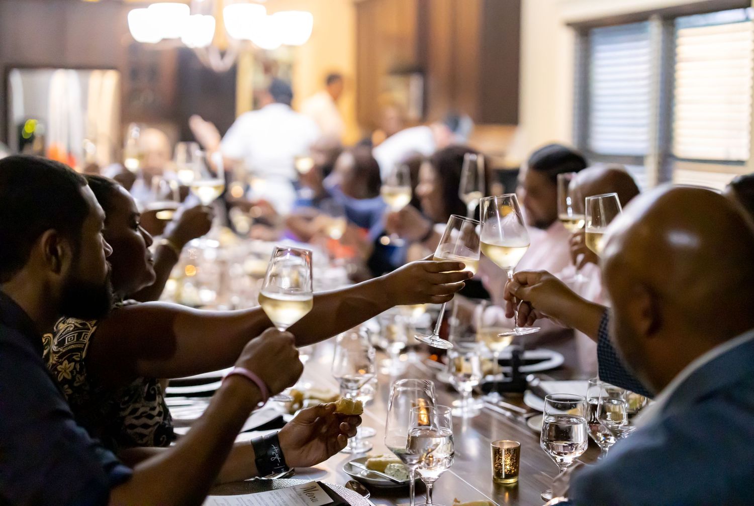 Elegant dinner setting with wine glasses and ambient lighting at a formal event.