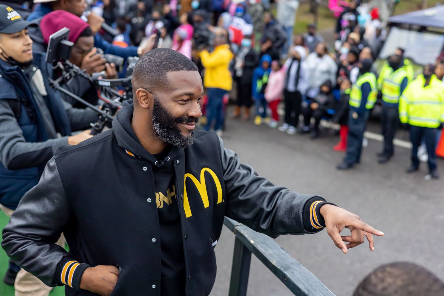 Person in McDonald's attire engaging with a crowd at an outdoor event.