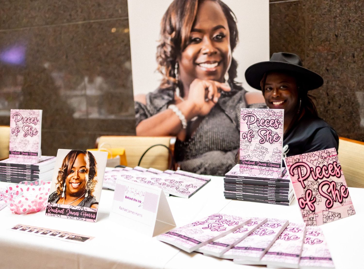 Book signing table display with promotional materials and merchandise.