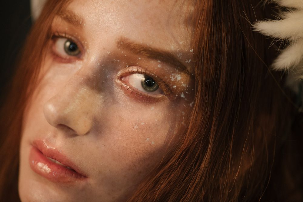 Beauty portrait with glittery eye makeup and natural lighting.