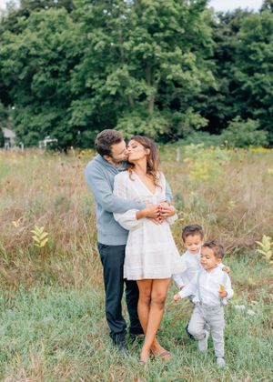 Sweet family moment captured in a golden meadow.