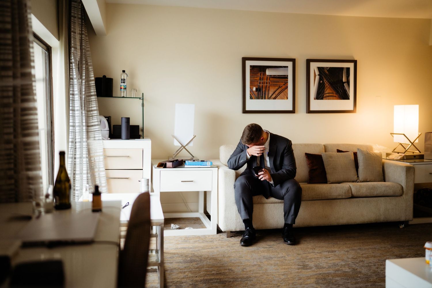 Moody hotel room scene with modern furnishings and warm lighting.