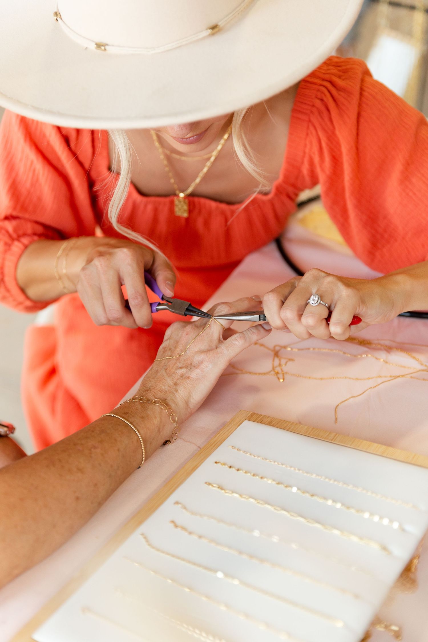 woman putting permeant jewelry on