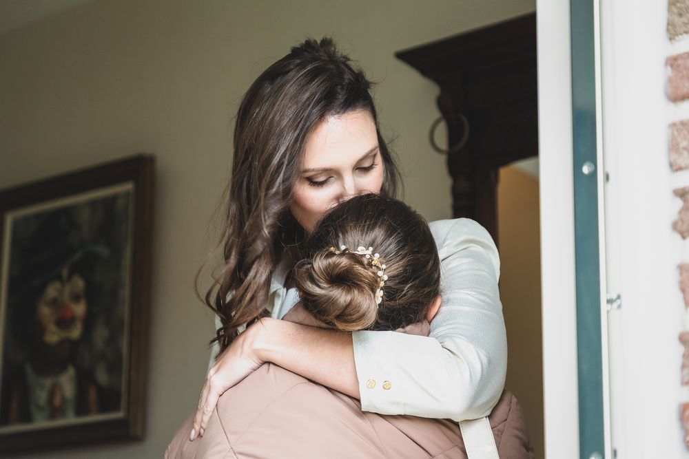 Two people embracing in an emotional moment indoors.