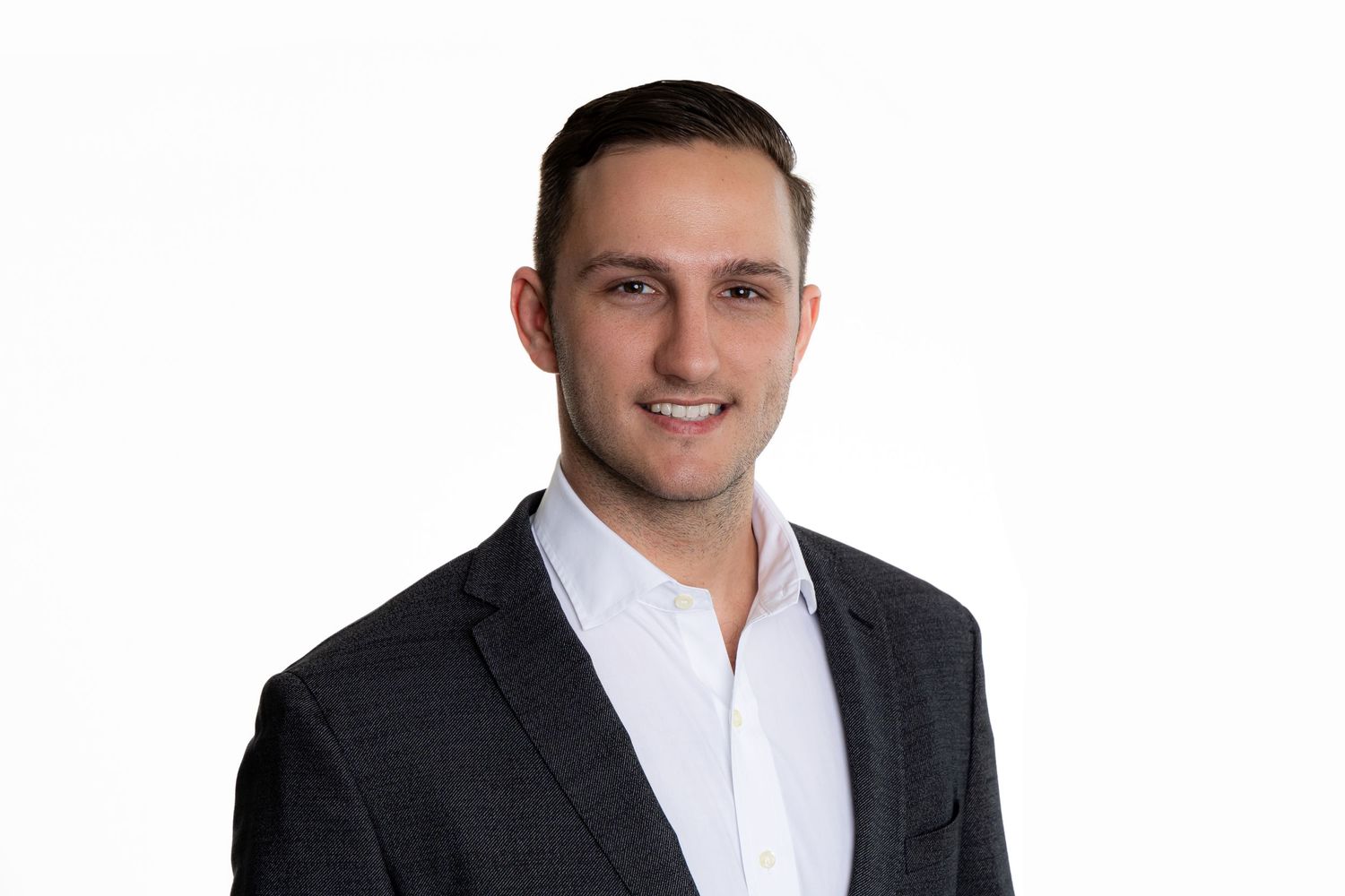 Professional portrait of a person in dark suit jacket and white shirt.