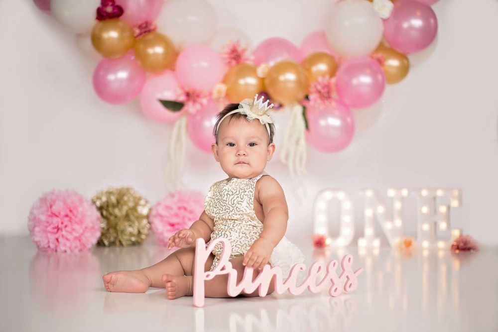 white, pink, and gold princess themed one year old girl portrait in Houston, TX.