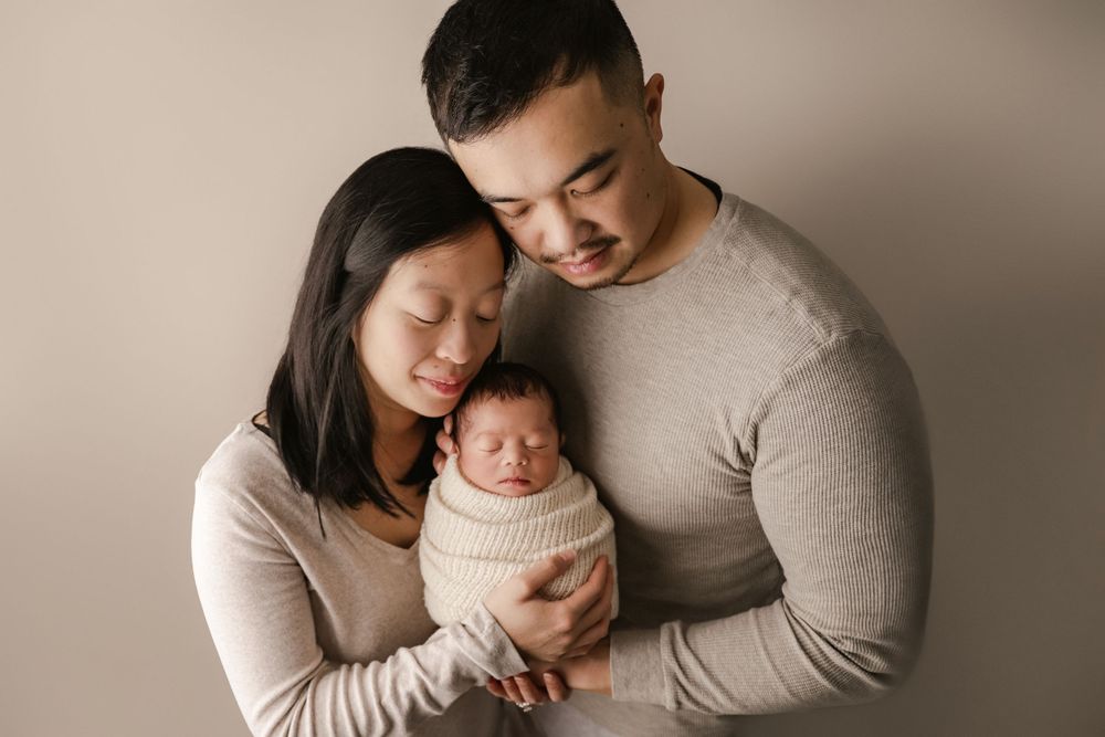 posed newborn portrait, studio newborn baby boy, parent pose or mom and dad