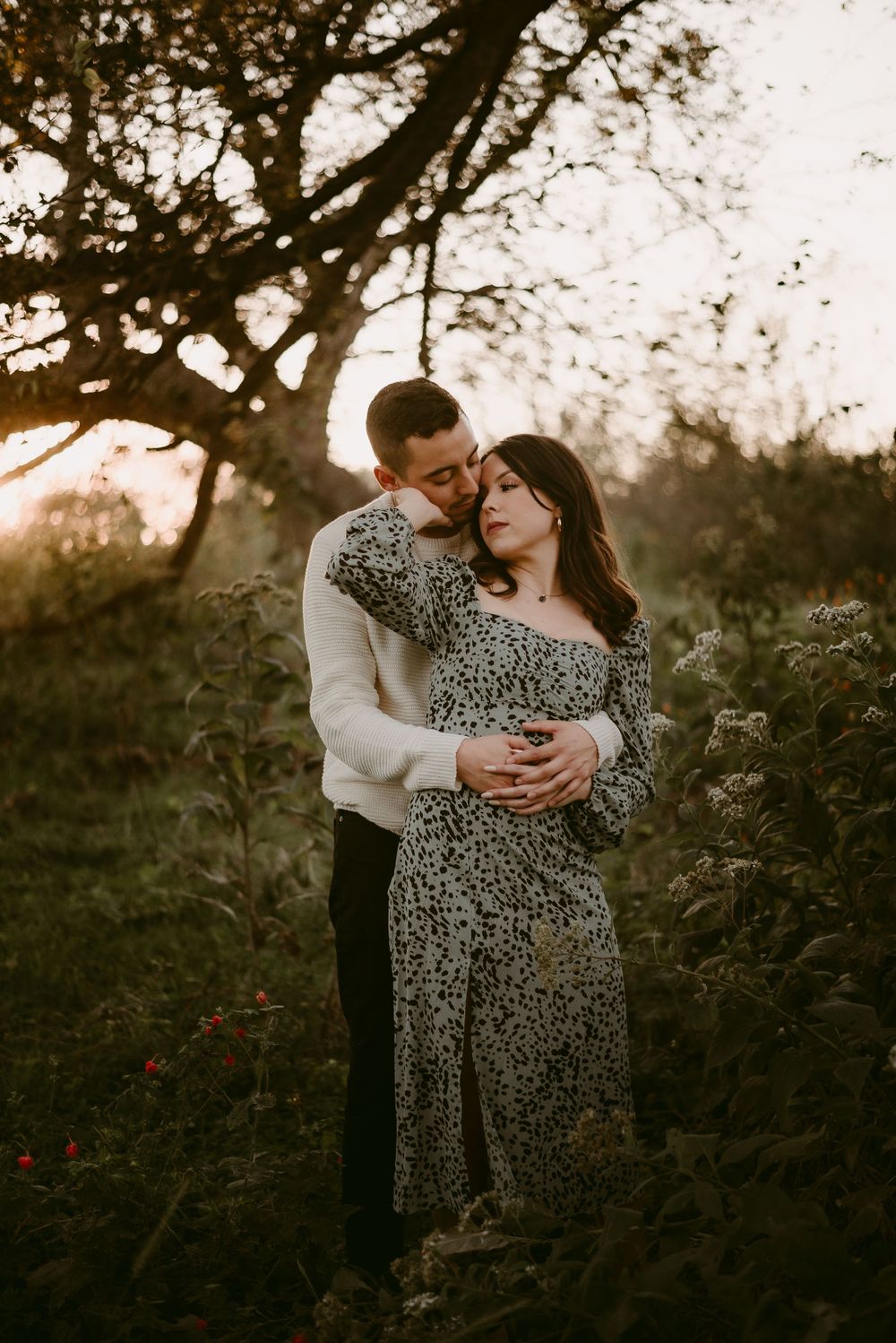 A Young Couple Holding One Another at Sunset in a Wooded area at Crescent Bend Park in Cibolo, Texas