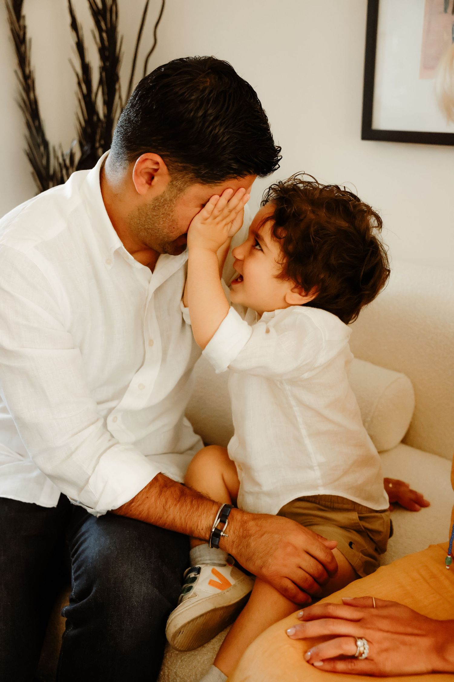 An intimate family moment captured on a couch showing affectionate interaction.