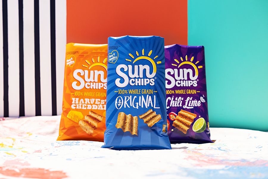 Colorful display of Sun Chips bags arranged against striped and color-blocked background.