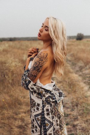 Artistic outdoor portraits featuring floral tattoo art and patterned clothing in natural light.