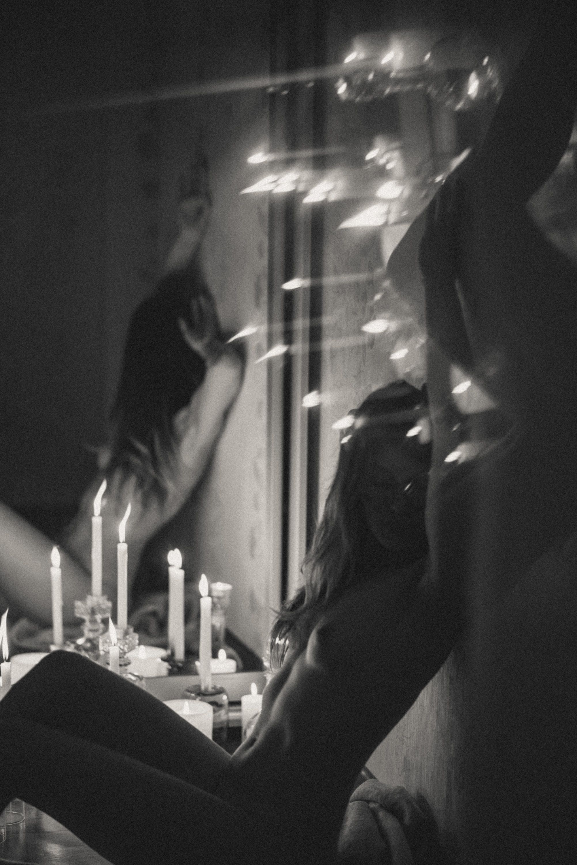 Moody candlelit scene with dramatic shadows and glowing lights.