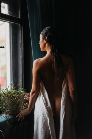 Moody interior photographs with natural window light and flowing white fabric.