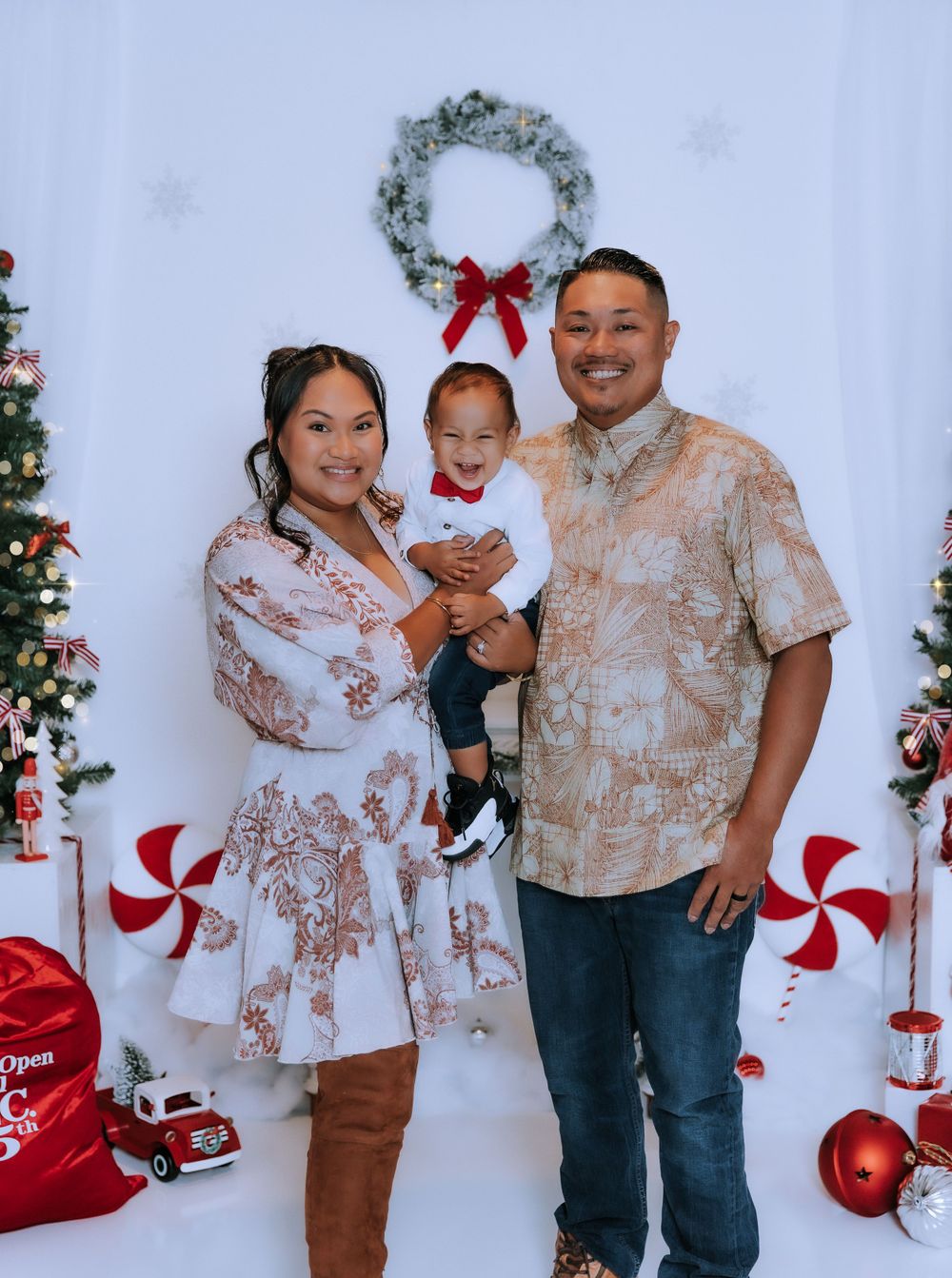 Family wearing matching outfits for Christmas photos with festive decorations.