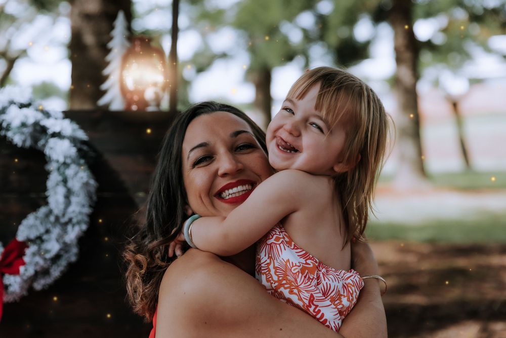 Candid family moments captured during outdoor Christmas photoshoot.