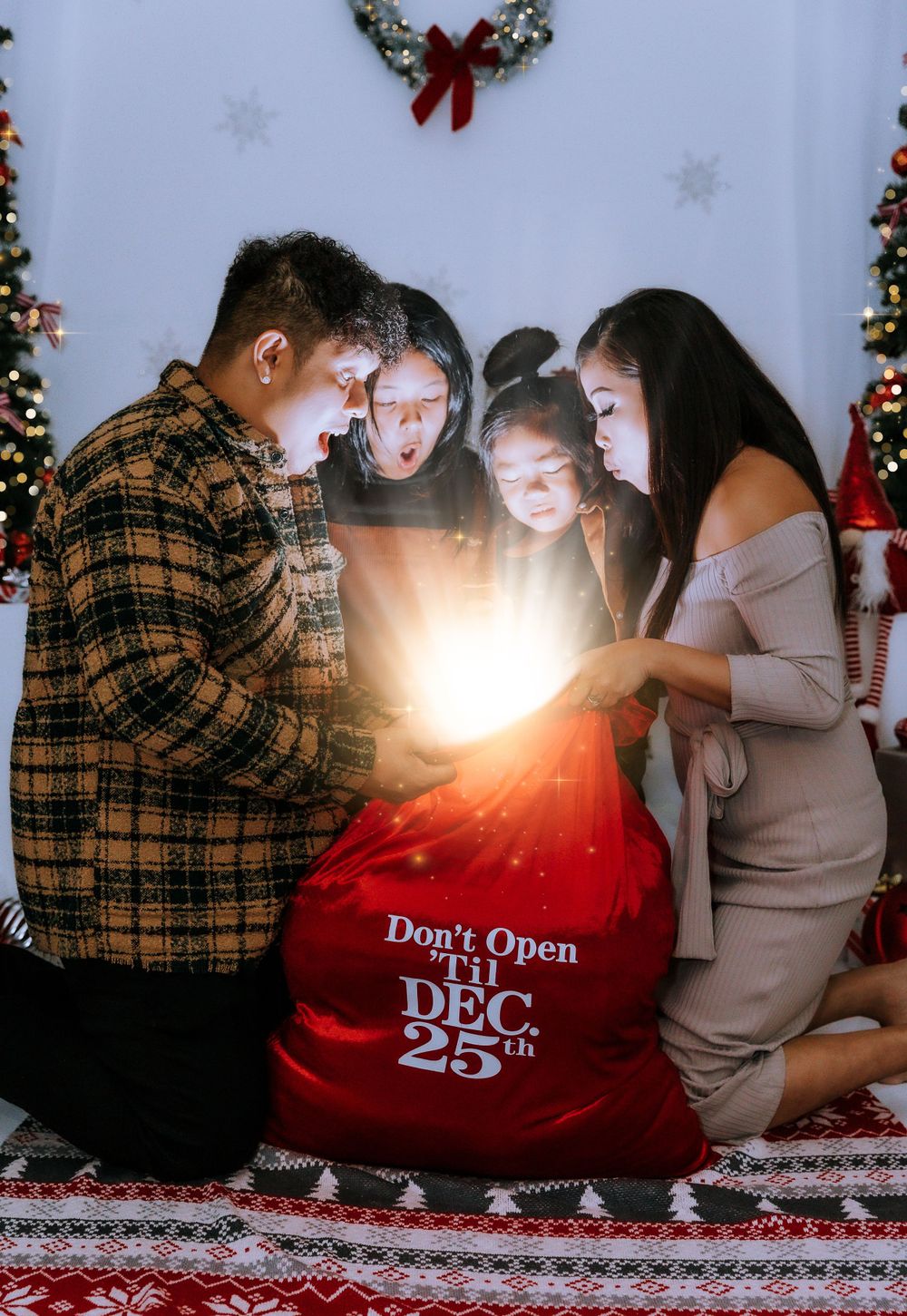 Family gathered around glowing Christmas gift bag creating magical holiday moment.