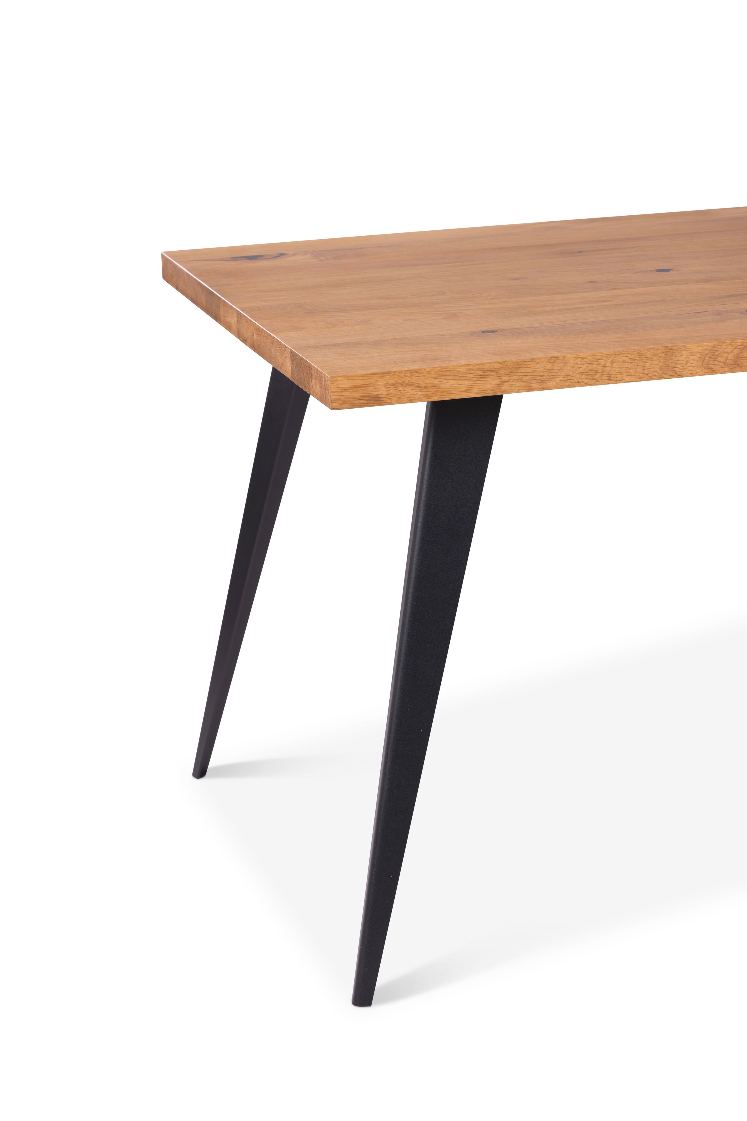 Modern dining table with natural wood top and black metal hairpin legs.