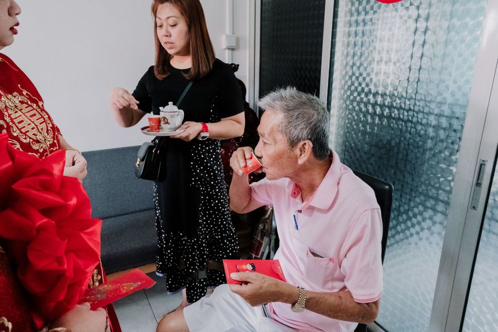 Guests enjoy tea and refreshments during a traditional Chinese celebration.