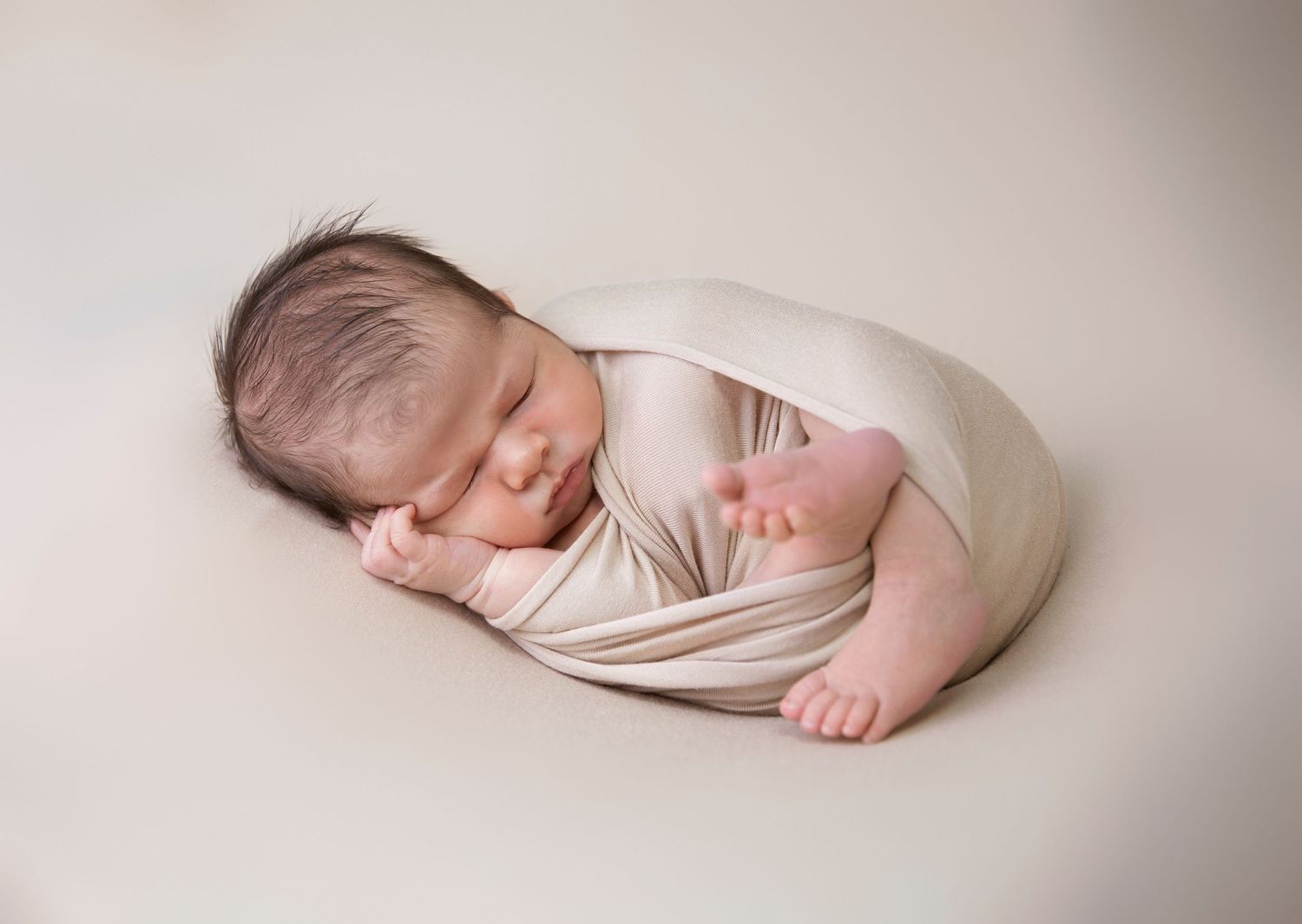 dark haired newborn baby boy photo shoot, cream wrap and matching backdrop