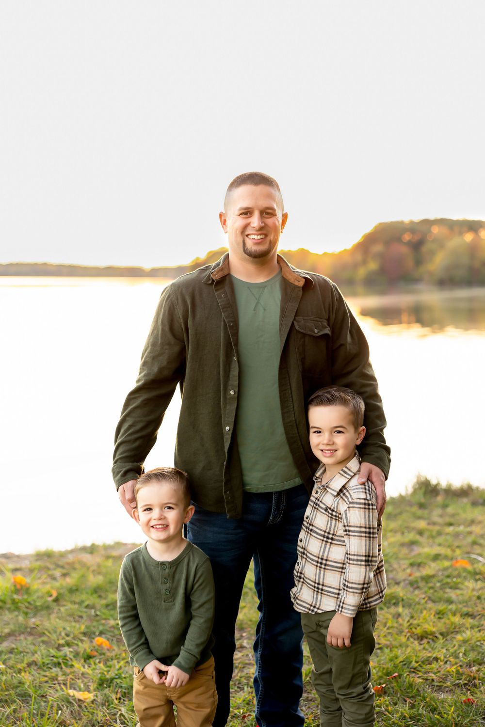 A casual outdoor portrait by a lake during golden hour.