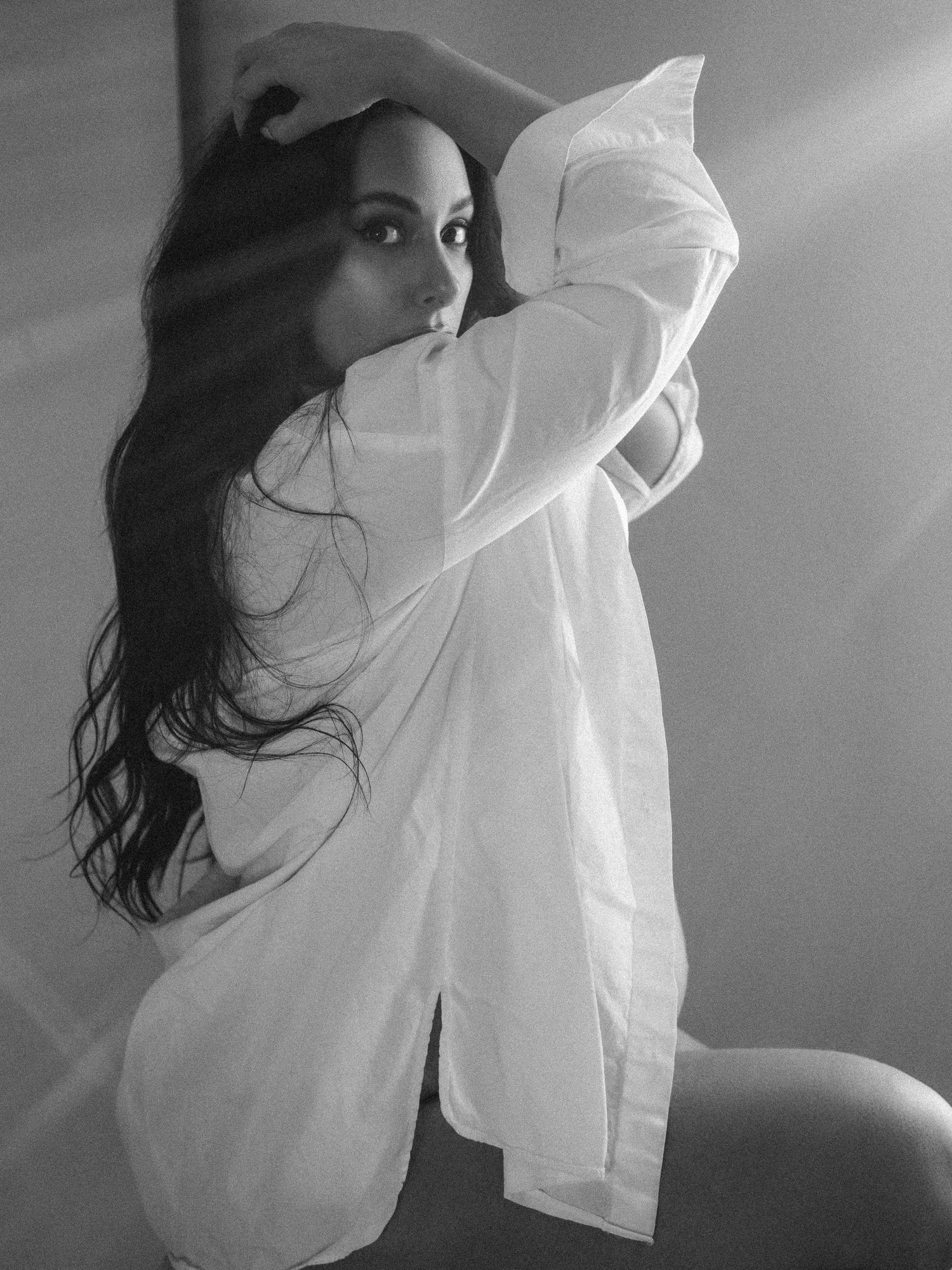 Black and white boudoir portrait in oversized white button-down shirt.